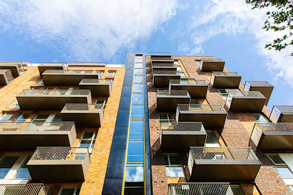 a tall apartment building with balconies on the side of it