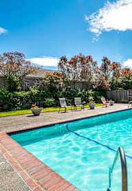 the pool is conveniently located in the backyard of the house
