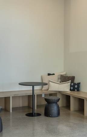 A seating area with small tables and benches at Northplace Apartment Homes, Salem, Oregon