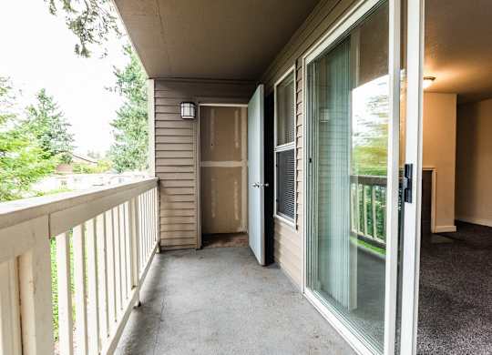 Tacoma Apartments - Sienna Apartments - Deck, Storage Room, Living Room, and Fireplace