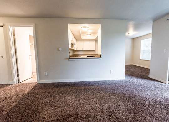 Tacoma Apartments - Sienna Apartments - Living Room, Kitchen, Dining Room, and Deck