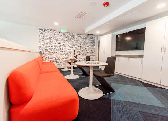 Seattle, WA Apartments for Rent - Icon Apartments Resident Lounge with Flat Screen TV and Cozy Table Seating at Icon Apartments, Seattle