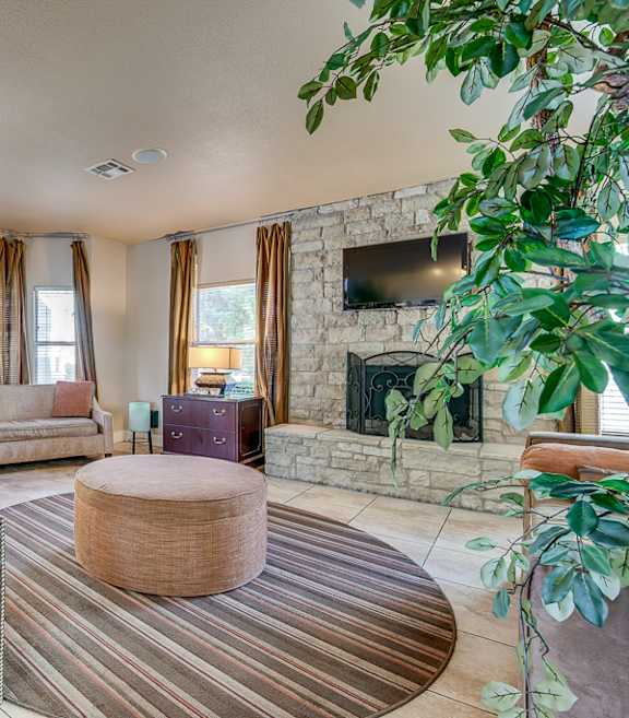 a living room with couches and a fireplace and a tv