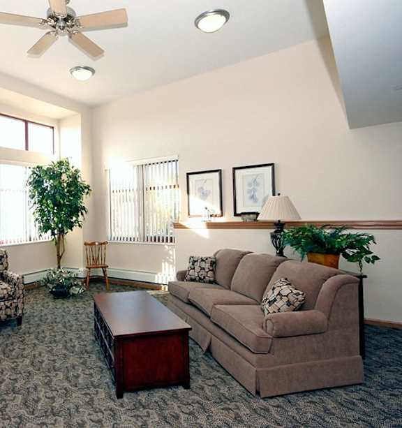 A living room with a ceiling fan and a couch.