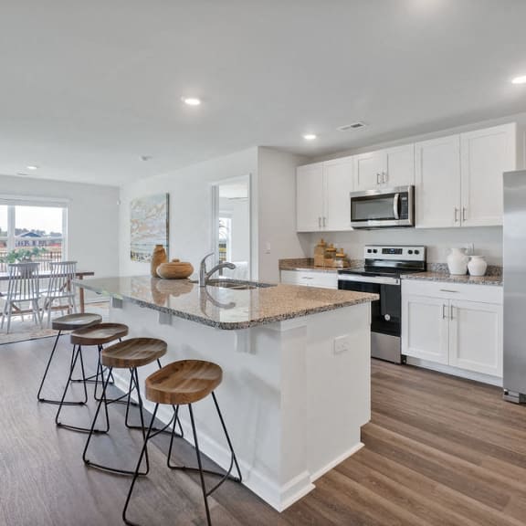 a kitchen with an island and three stools