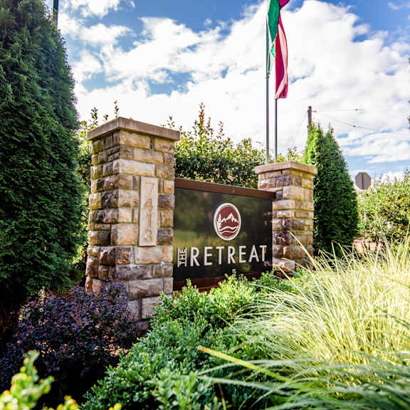 a sign for a restaurant in front of a flag
