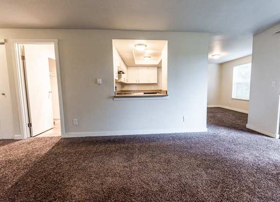Tacoma Apartments - Sienna Apartments - Living Room, Kitchen, Dining Room, and Deck
