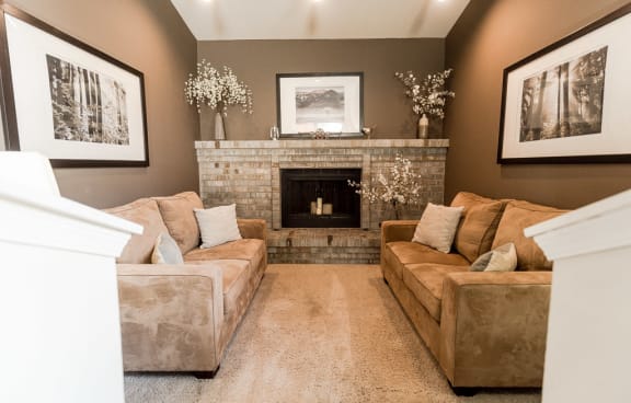 a living room with a fireplace and couches at Cambridge on Seventh, Puyallup, WA, 98372