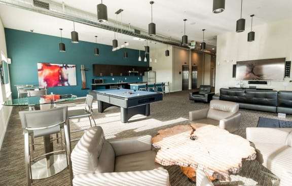 A modern living room with a pool table and a television. at The Platform, Kent, Washington