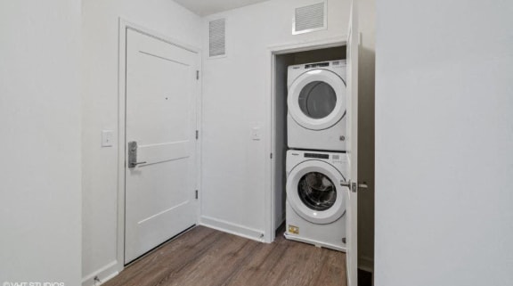 a white laundry room with a washer and dryer in it
