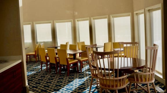 a dining room with wooden tables and chairs