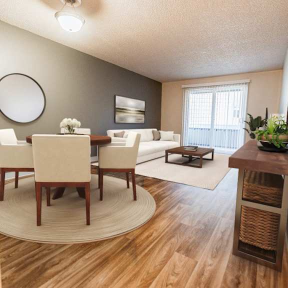 A dining room with a round table and chairs.