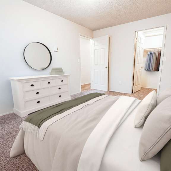 A bedroom with a bed, dresser, and mirror.
