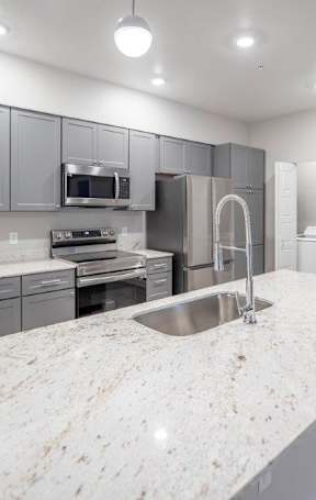 a view of a kitchen with white tiled flooring at Inspiration Apartments, Cottonwood, AZ, 86326