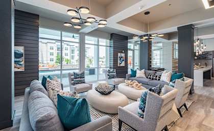 A modern living room with grey and teal accents.