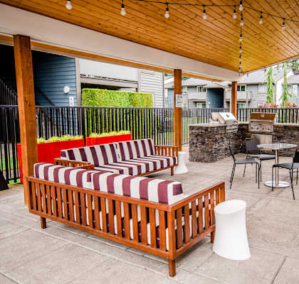 a covered patio with furniture and a table and chairs at Aero Apartments, Washington, 98444