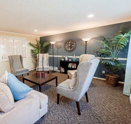 a living room with couches chairs and a coffee table at The Verandas, Washington, 98466
