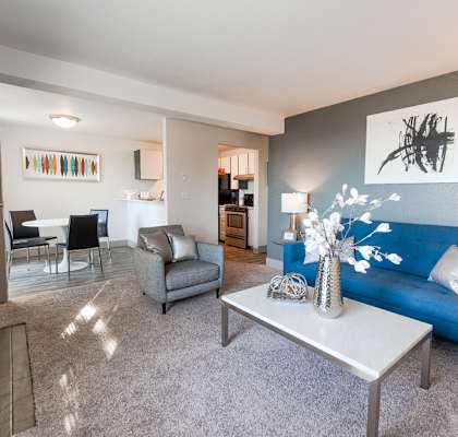 a living room with a blue couch and a white table at The Lodge at Madrona, Washington, 98409