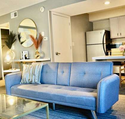 a living room with a blue couch and a table