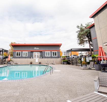 A small pool in a courtyard surrounded by buildings. at The Aviator, Washington