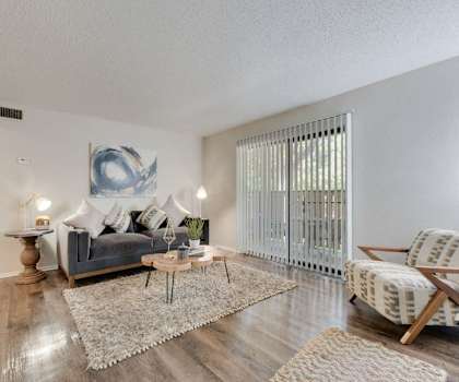 a living room with a couch and a sliding glass door