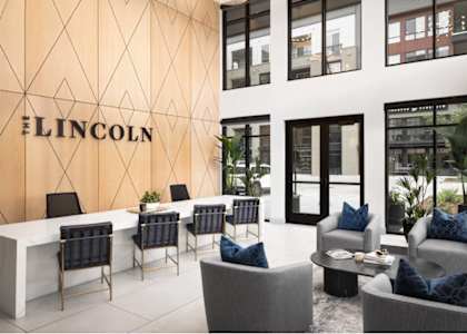 A modern office space with the word "LINCOLN" on the wall.