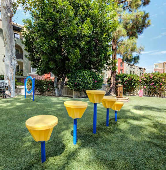 a basketball court in front of an apartment building at The Reserve at Warner Center Apartments, California