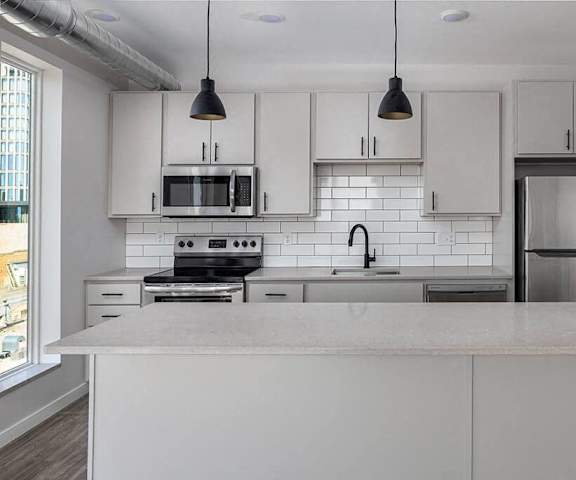 a kitchen with white cabinets and a counter top  at Kesler Apartments in Downtown Fargo, Fargo, North Dakota, 58102