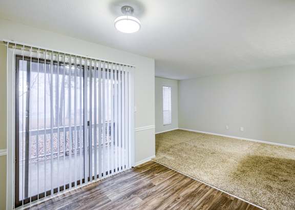 a living room filled with furniture and a ceiling fan