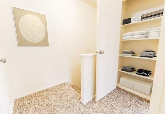 a closet with shelves and a white door
