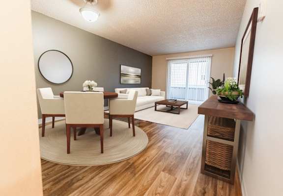 A dining room with a round table and chairs.