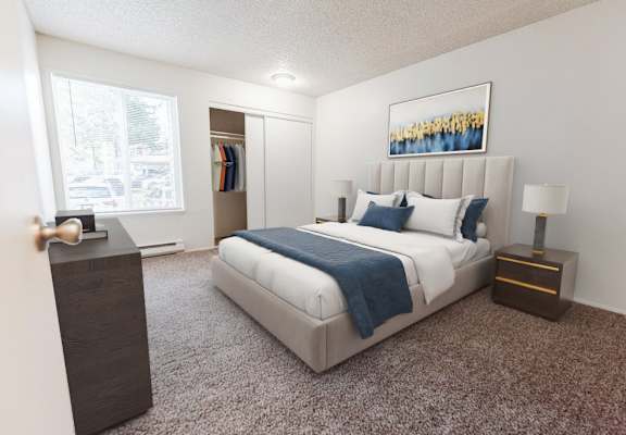 A bedroom with a large bed, a nightstand, and a carpeted floor.