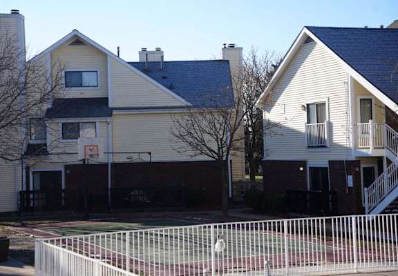 a white house with a fence in front of it