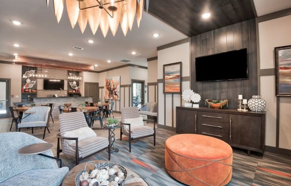 a community clubhouse with couches and chairs and a tv at Sterling Creek, Richmond Hill, 31324