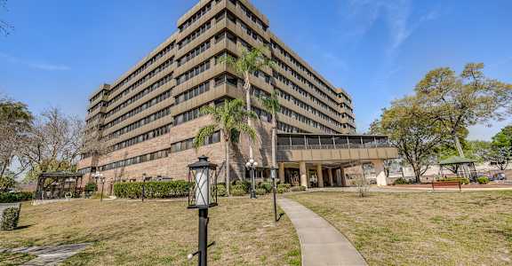 a large building with a grassy area in front of it
