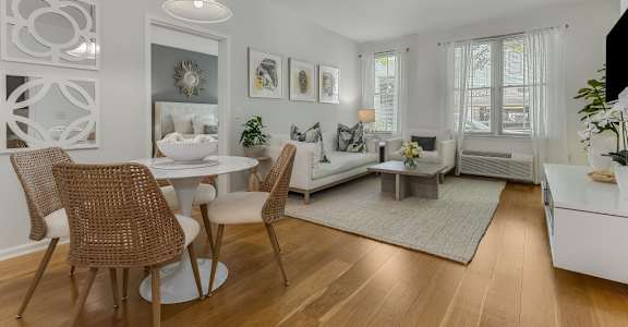 A modern dining room with a white table and chairs.