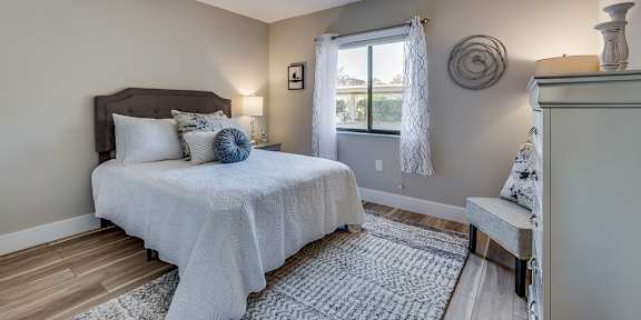 a bedroom with a bed and a dresser