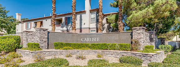 A house with a sign that says "CARLISLE" in front of it.