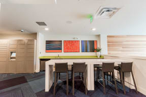 Seattle, WA Apartments for Rent - Icon Apartments Resident Lounge with Flat Screen TV and Cozy Table Seating