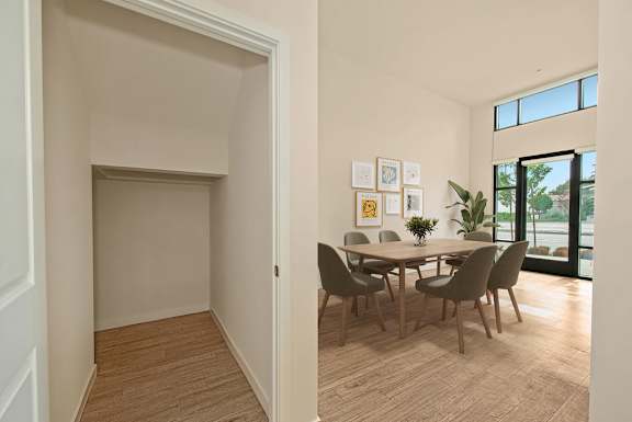 A dining room with a table and chairs.