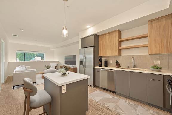 A modern kitchen with a dining area and a refrigerator.