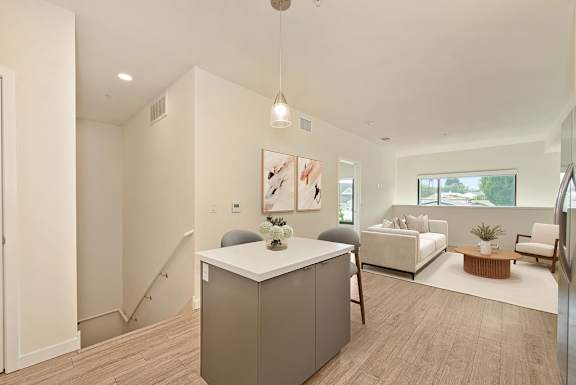 A modern living room with a white cabinet in the center.