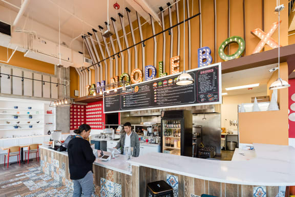 people ordering at the counter of a restaurant