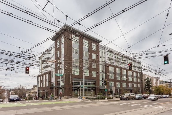 a large brick building with many windows and trolley wires in front of it