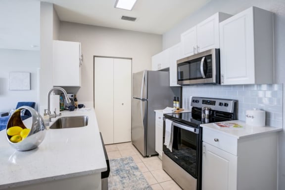 Fully Equipped Kitchen Includes Frost-Free Refrigerator, Electric Range, & Dishwasher at Village at Lake  Highland, Lakeland, FL, 33813