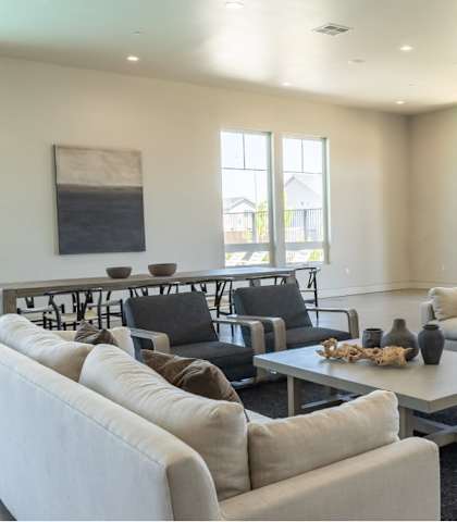 A living room with a white couch, black chairs, and a coffee table at Northplace Apartment Homes, Oregon, 97305