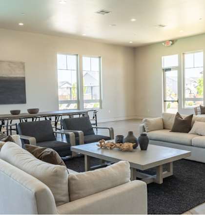 A living room with a white couch, black chairs, and a coffee table at Northplace Apartment Homes, Oregon, 97305