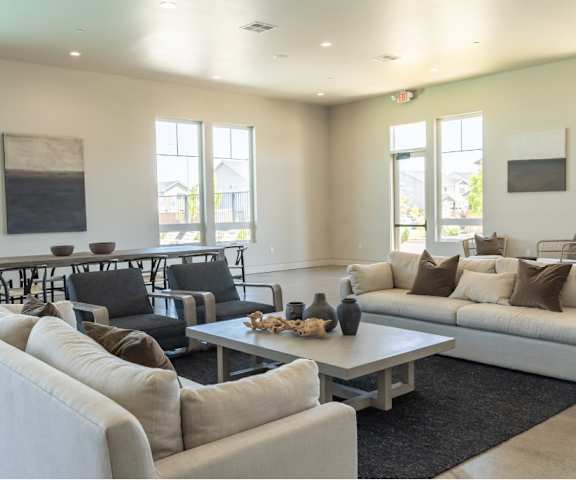 A living room with a white couch, black chairs, and a coffee table at Northplace Apartment Homes, Oregon, 97305