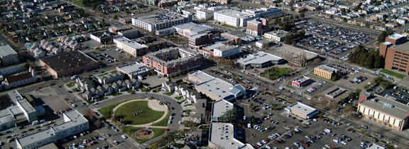 A cityscape with buildings and a large open space in the center.