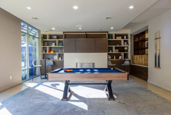 a pool table in a living room with a fireplace